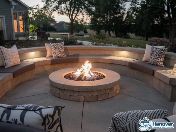 Concrete patio with a built-in fire pit and comfortable seating.